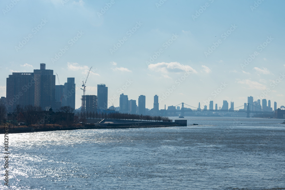 The East River between Queens and Manhattan in New York City with the Williamsburg Bridge in the distance