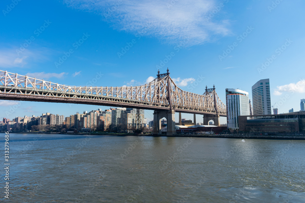 Queensboro Bridge along the East River with the Roosevelt Island Skyline in New York City