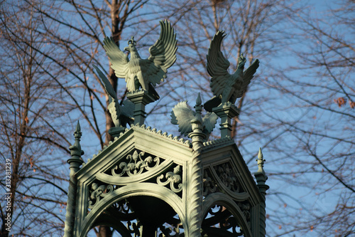 Eagle sculptures on top of  the roof of a mausoleum at Invalidenfriedhof photo