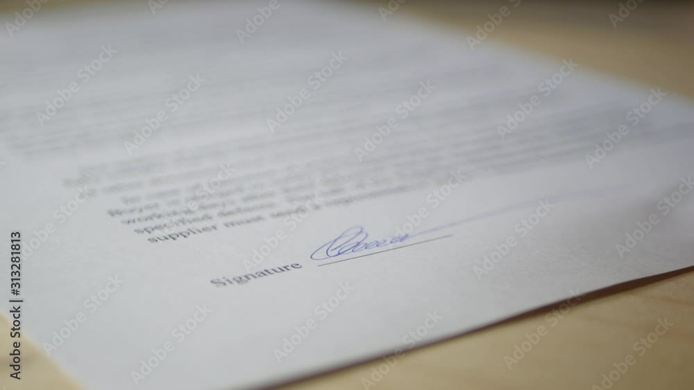 A business man signs a contract details of a business contract. A business man signs a contract details of a business contract.
