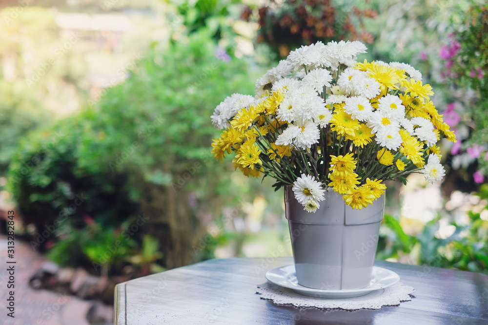 Beautiful yellow and white flowers on table