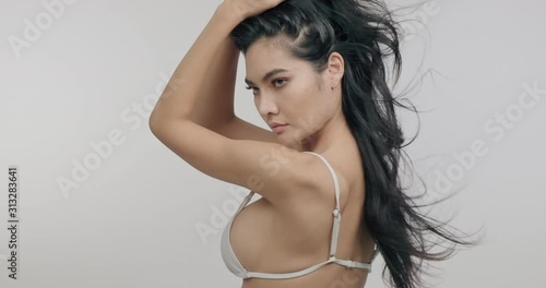 Very sexy woman showing her sexy back posing in slow motion. Asian woman in bikini. Slow motion. Sexy woman health and beauty concept.