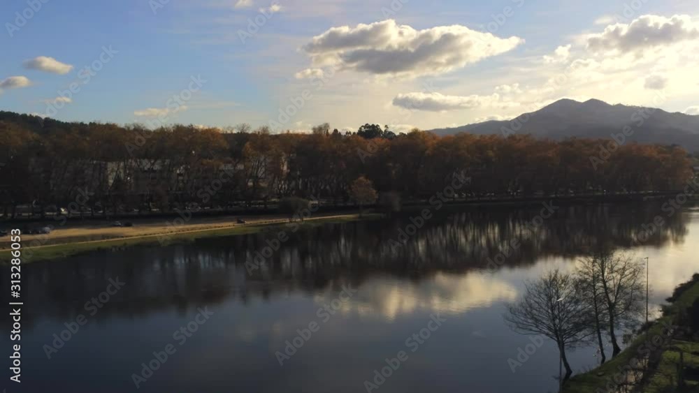 Aerial, pan, drone shot of the Lima river, on a sunny autumn day, in Ponte de Lima, Viana do castelo, Northern Portugal Aerial, pan, drone shot of the Lima river, on a sunny autumn day, in Ponte de Lima, Viana do castelo, Northern Portugal