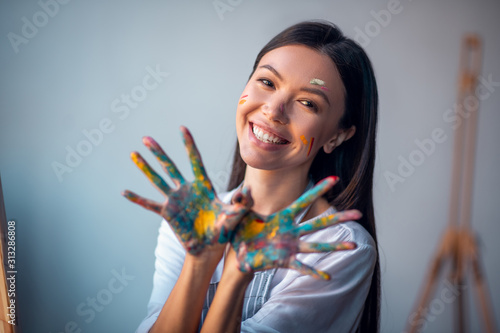 Joyful happy woman showing her hands to you photo
