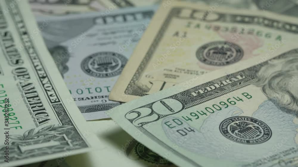 dollar banknotes of different face value lie in disorder and rotate under electric light extreme close view dollar banknotes of different face value lie in disorder and rotate under electric light extreme close view
