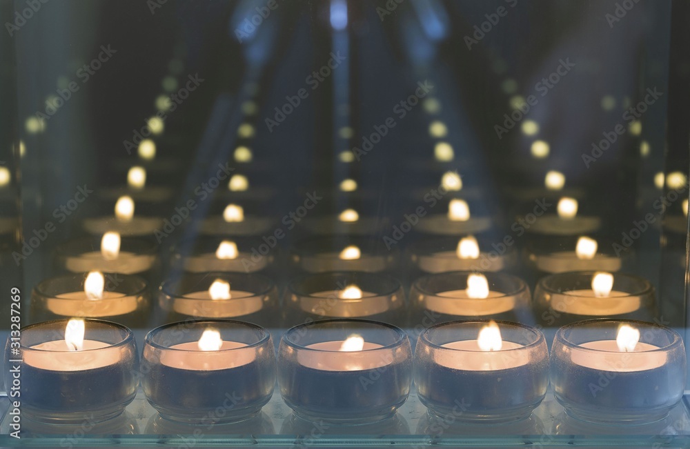 Beautiful view of candlelights with mirror reflection. Holidays romantic concept. 