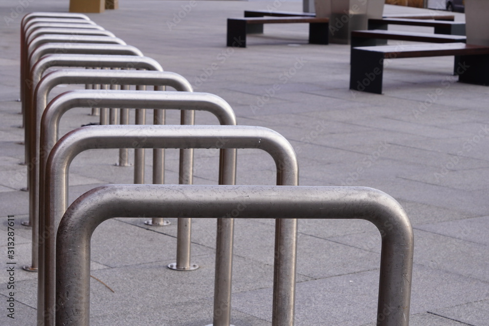 empty metal construction for Parking at the house or shop of bicycles or scooters, environmental transport in the city. Perspective, looking into the distance.