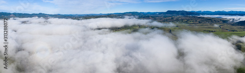 A low blanket of clouds drifts slowly over the rural landscape of central Oregon. This beautiful region is known for its extensive farming and nearby logging communities.