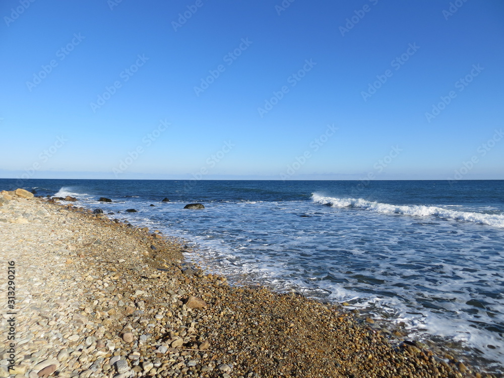 Clear blue sky over the rocky beach at Montauk, Long Island, New York.