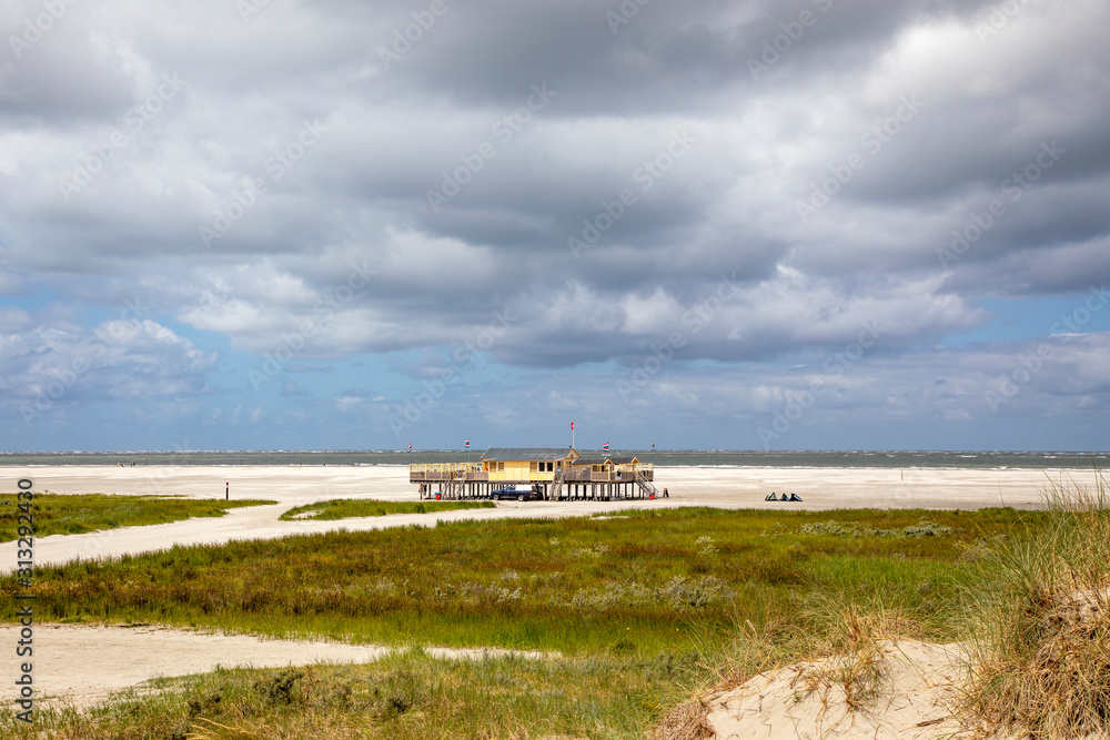 Beach pavilion on the beach of Schiermonnikoog on the North Sea seen from the dunes Beach pavilion on the beach of Schiermonnikoog on the North Sea seen from the dunes