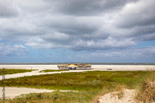 Beach pavilion on the beach of Schiermonnikoog on the North Sea seen from the dunes © Clara