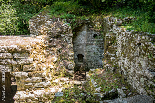 Building ruins. Beautiful warm spring day and archeological ruins at Butrint National Park, Albania, UNESCO heritage. Travel photography with fresh green flora