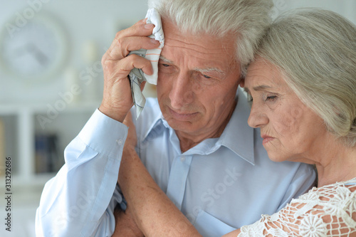 Close up portrait of sick elderly woman and man at home