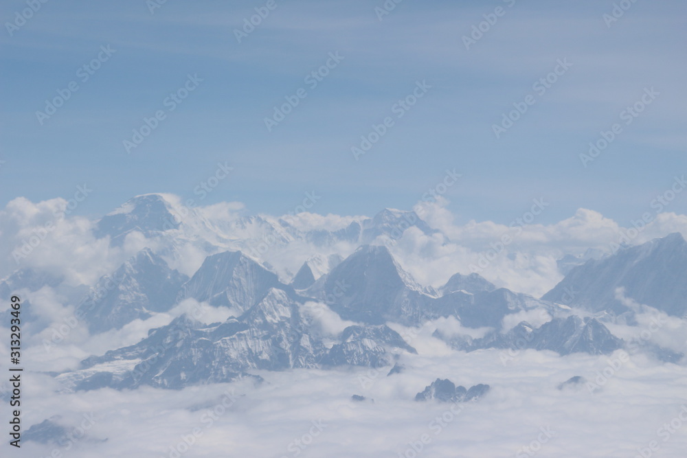 A beautiful photo of a mountain with glacier and snow on it from a height above the clouds A beautiful photo of a mountain with glacier and snow on it from a height above the clouds