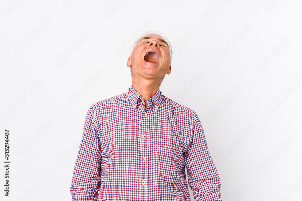 Senior caucasian man isolated relaxed and happy laughing, neck stretched showing teeth. Senior caucasian man isolated relaxed and happy laughing, neck stretched showing teeth.