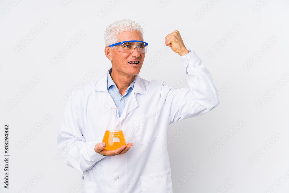 Mature chemical man isolated raising fist after a victory, winner concept. Mature chemical man isolated raising fist after a victory, winner concept.