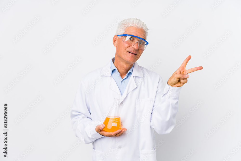 Mature chemical man isolated joyful and carefree showing a peace symbol with fingers. Mature chemical man isolated joyful and carefree showing a peace symbol with fingers.