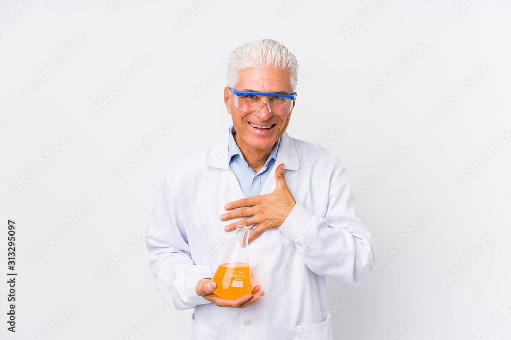 Mature chemical man isolated laughs out loudly keeping hand on chest. Mature chemical man isolated laughs out loudly keeping hand on chest.