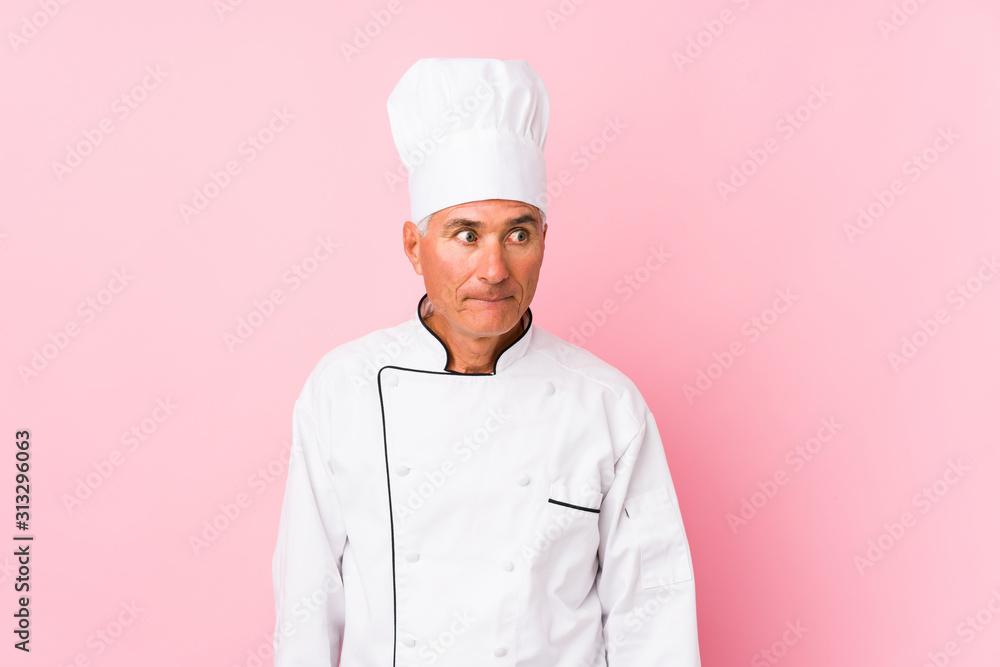 Middle aged cook man isolated confused, feels doubtful and unsure. Middle aged cook man isolated confused, feels doubtful and unsure.