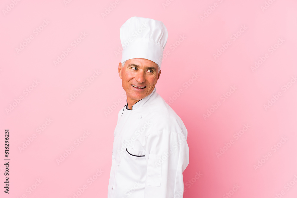 Middle aged cook man isolated looks aside smiling, cheerful and pleasant. Middle aged cook man isolated looks aside smiling, cheerful and pleasant.