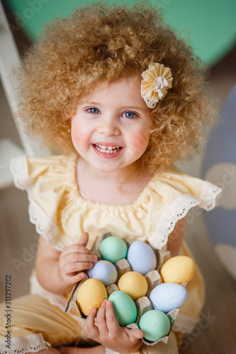 little blonde girl in a yellow suit for Easter
