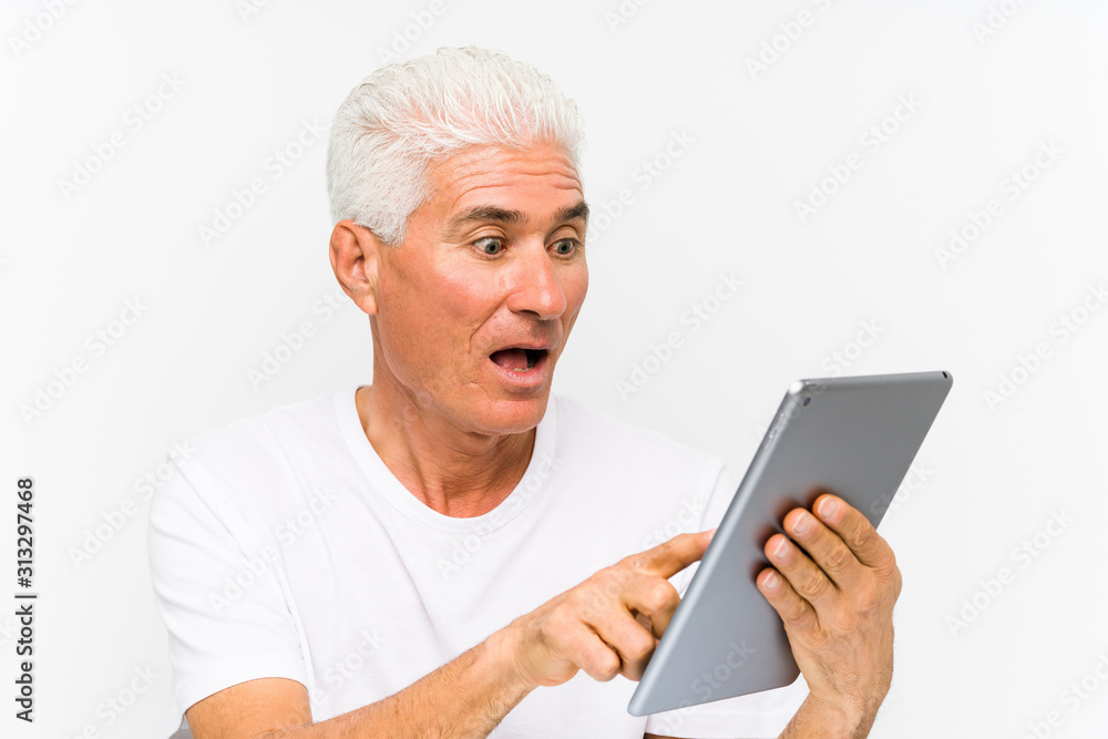 Mature caucasian man holding a tablet Mature caucasian man holding a tablet