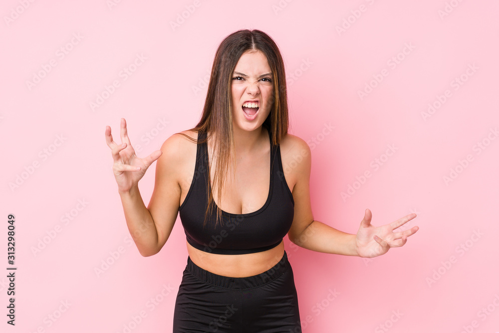 Young fitness caucasian woman isolated screaming with rage. Young fitness caucasian woman isolated screaming with rage.