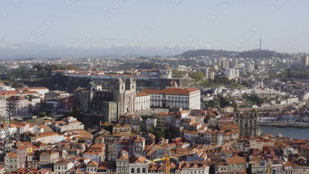 Beautiful aerial panoramic view on the Porto Cathedral, ancient building in Portugal, and old european city at sunny autumn day, red-tiled roofs and buildings, river Douro, static shooting Beautiful aerial panoramic view on the Porto Cathedral, ancient building in Portugal, and old european city at sunny autumn day, red-tiled roofs and buildings, river Douro, static shooting