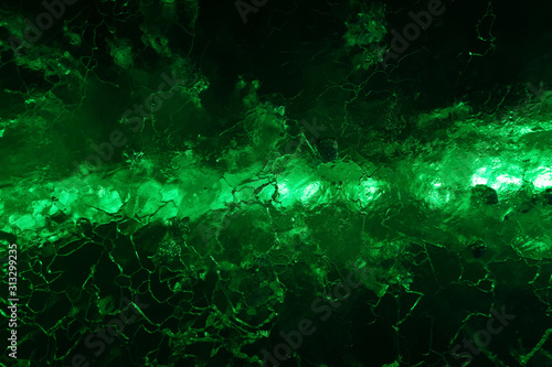 abstract dark green background - glow through cracked ice © Evgeny