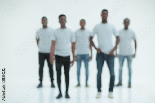 blurry image of a group of young men in white t-shirts