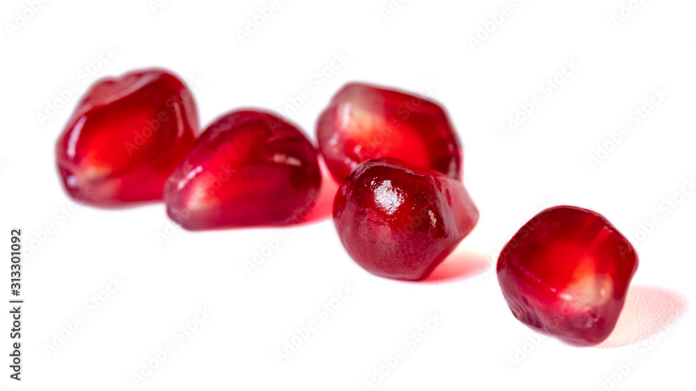Fresh pomegranate seeds isolated on white background. Close up. Fresh pomegranate seeds isolated on white background. Close up.