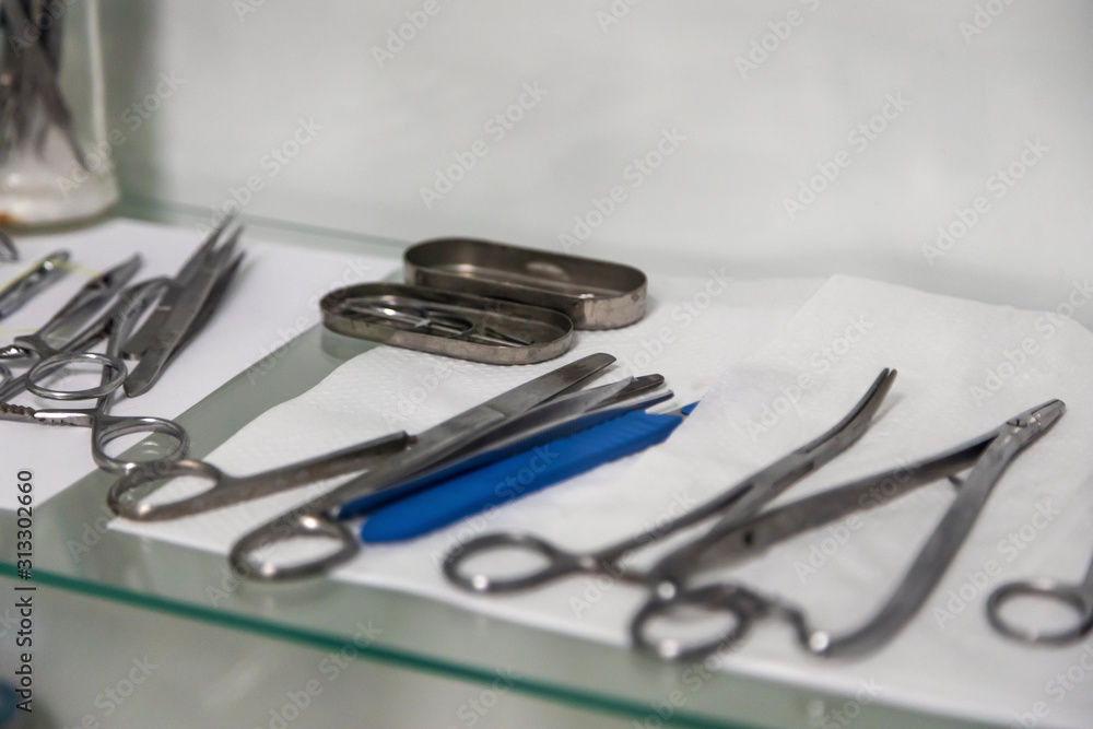 Sterile medical instruments are prepared for surgery in a veterinary clinic. Close-up, selective focus. Sterile medical instruments are prepared for surgery in a veterinary clinic. Close-up, selective focus.