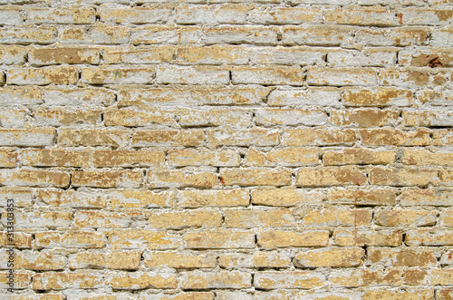 Weathered yellow brick wall