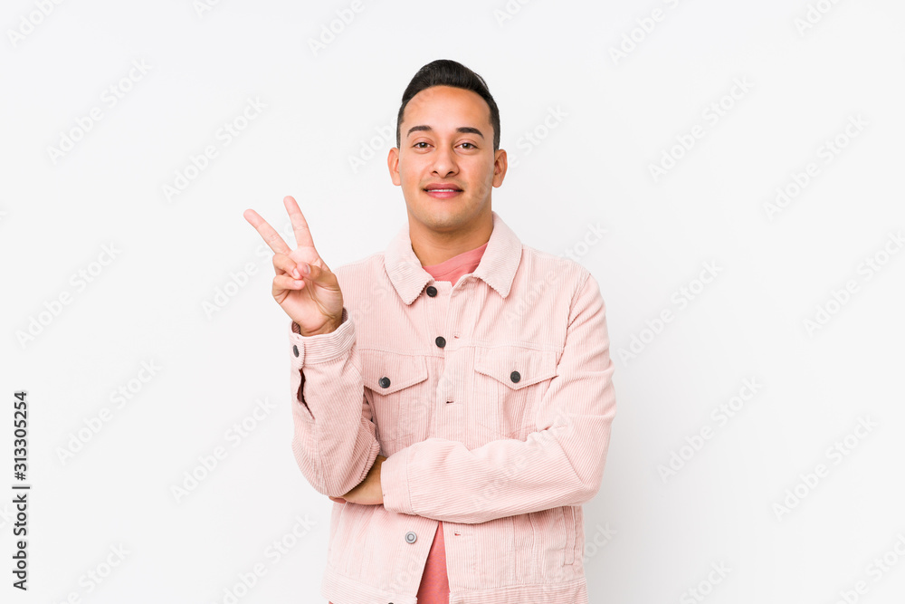Young latin man posing isolated showing number two with fingers. Young latin man posing isolated showing number two with fingers.