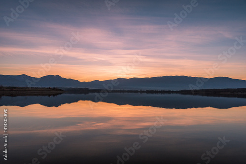 Beautiful lake view on sunset. With water, mountain and colorful clouds © Petar