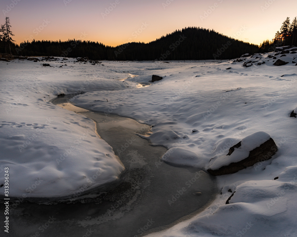 Sunrise in the winter mountain. Bottom of the empty lake Shiroka poliana in Rhodope mountain, Bulgaria Sunrise in the winter mountain. Bottom of the empty lake Shiroka poliana in Rhodope mountain, Bulgaria