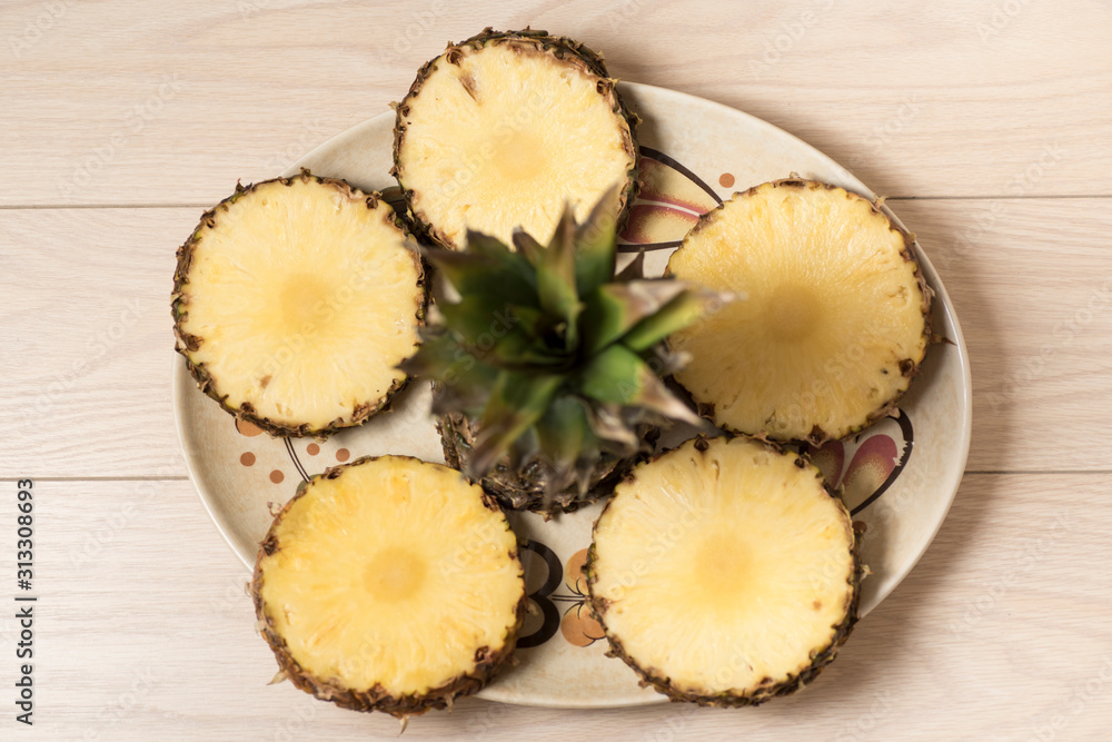 fresh and juicy pineapple pieces on a yellow homogeneous surface. Fruit ready to eat fresh and juicy pineapple pieces on a yellow homogeneous surface. Fruit ready to eat