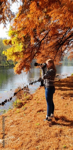 Girl in autumn city park. Bright sunlight and golden trees, fall season © liliportfolio