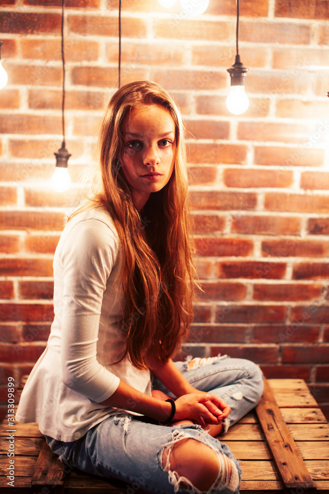 young teenage girl posing cheerful in modern loft studio interior with many lights, lifestyle holiday people concept young teenage girl posing cheerful in modern loft studio interior with many lights, lifestyle holiday people concept