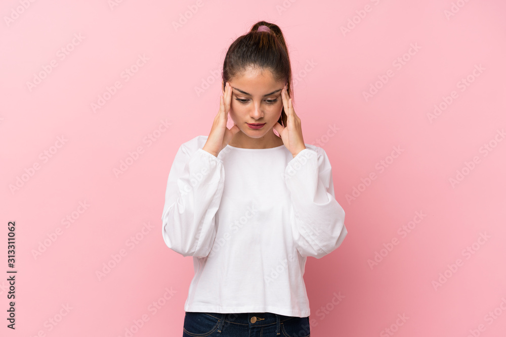 Young brunette girl over isolated pink background with headache Young brunette girl over isolated pink background with headache
