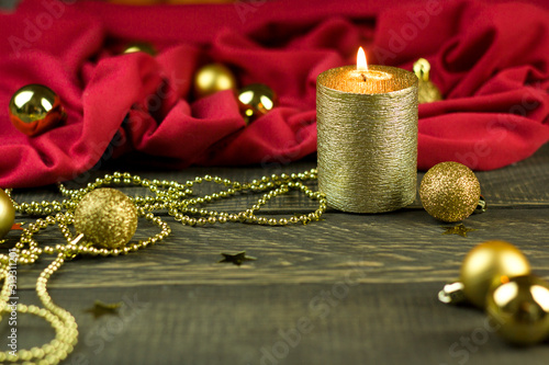 Candlestick, candles and Christmas decorations on snow against the background of a wooden board. Christmas background, greeting card comfort evening winter romance gold jewelry
