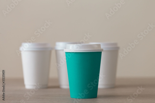 Food. Multi colored paper cup cappuccino in beige background