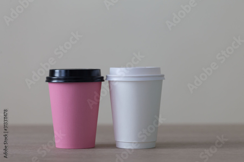 Food. Multi colored paper cup cappuccino in beige background
