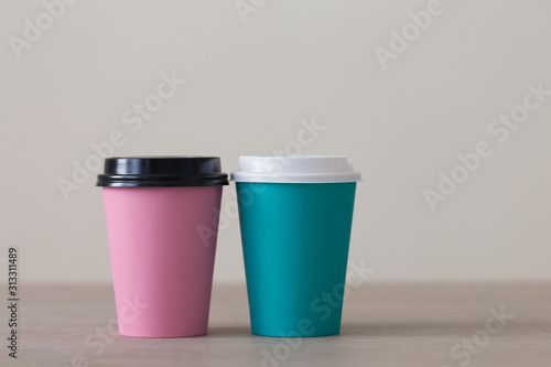 Food. Multi colored paper cup cappuccino in beige background
