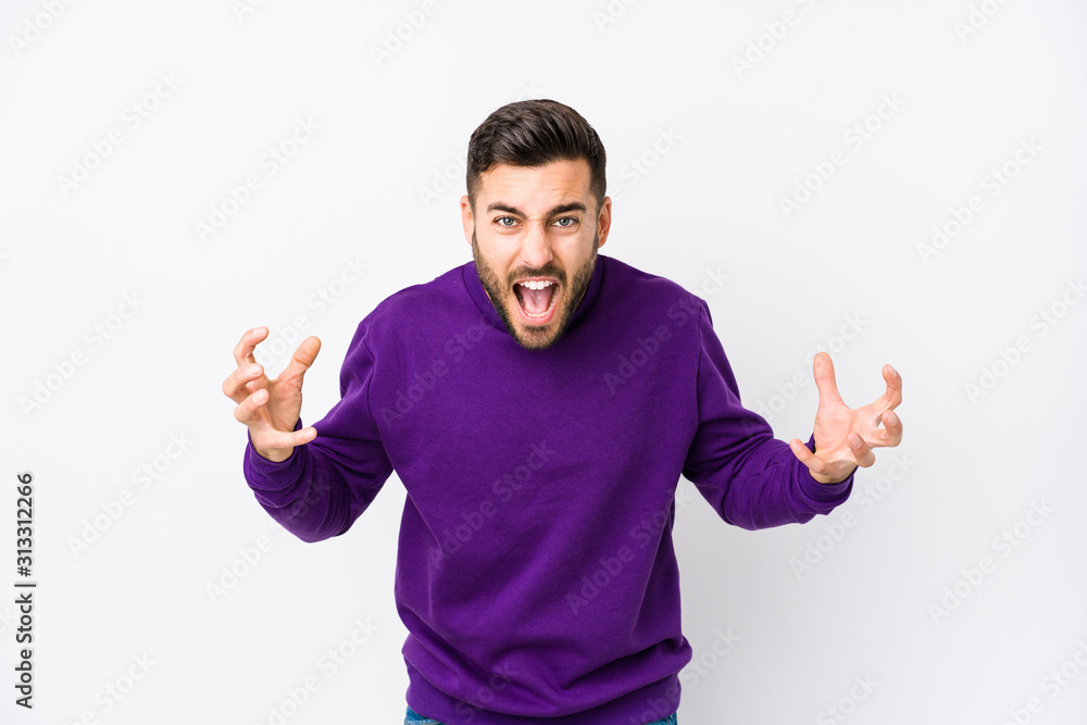 Young caucasian man against a white background isolated screaming with rage. Young caucasian man against a white background isolated screaming with rage.