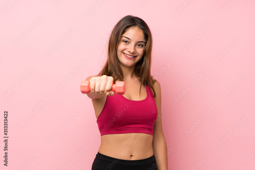 Young sport girl over isolated pink background making weightlifting Young sport girl over isolated pink background making weightlifting