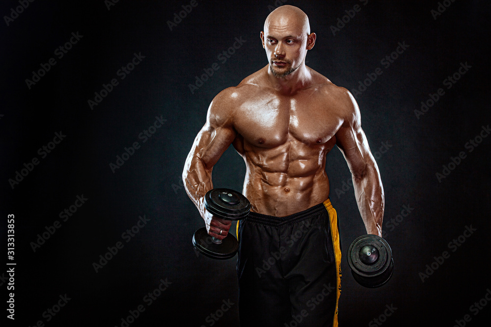 Strong and fit man bodybuilder. Sporty muscular guy with dumbbells. Sport and fitness motivation. Individual sports recreation. Strong and fit man bodybuilder. Sporty muscular guy with dumbbells. Sport and fitness motivation. Individual sports recreation.