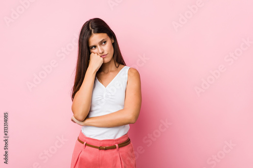 Young cute woman who feels sad and pensive  looking at copy space.