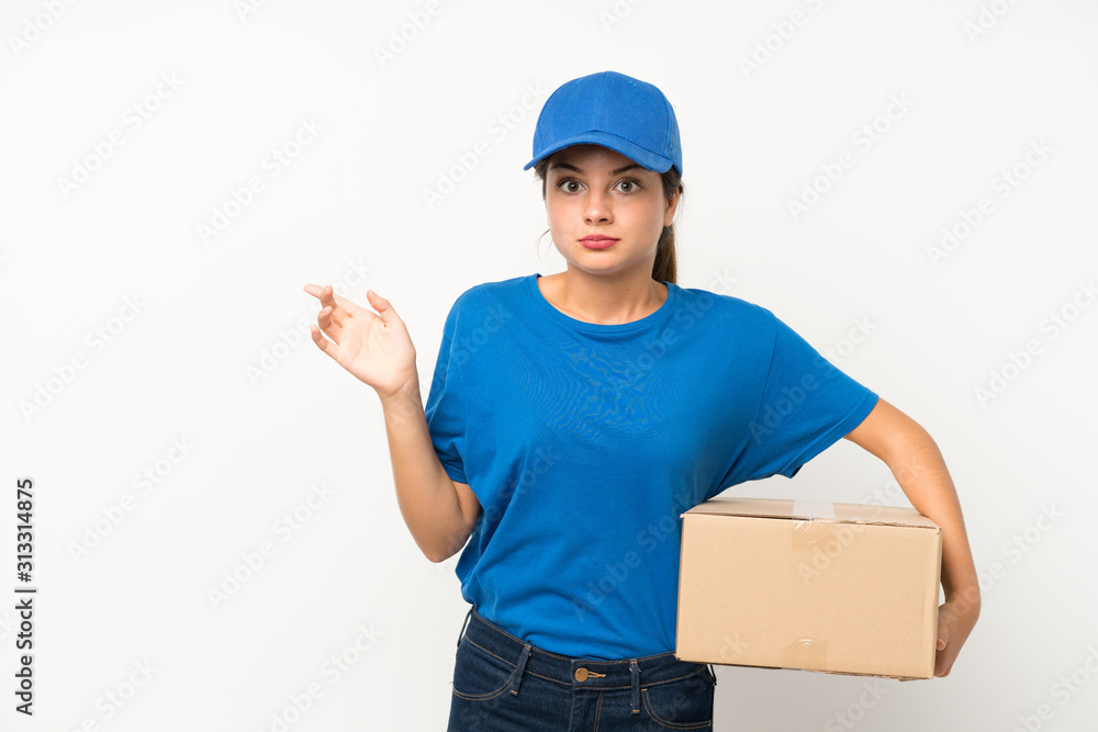 Young delivery girl over isolated white background pointing to the laterals having doubts Young delivery girl over isolated white background pointing to the laterals having doubts