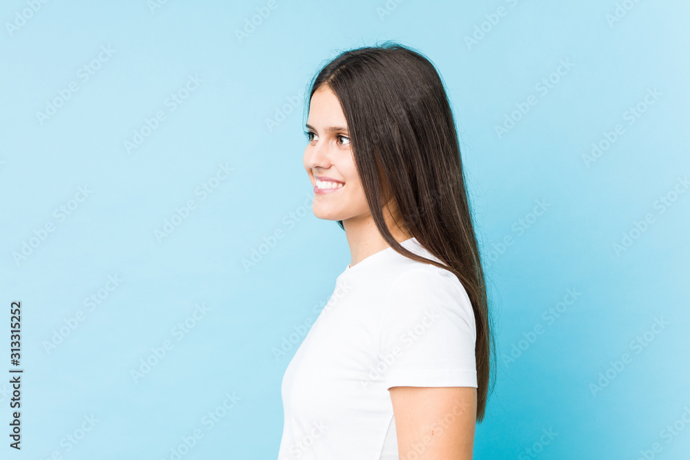 Young caucasian girl face closeup isolated in a blue background Young caucasian girl face closeup isolated in a blue background